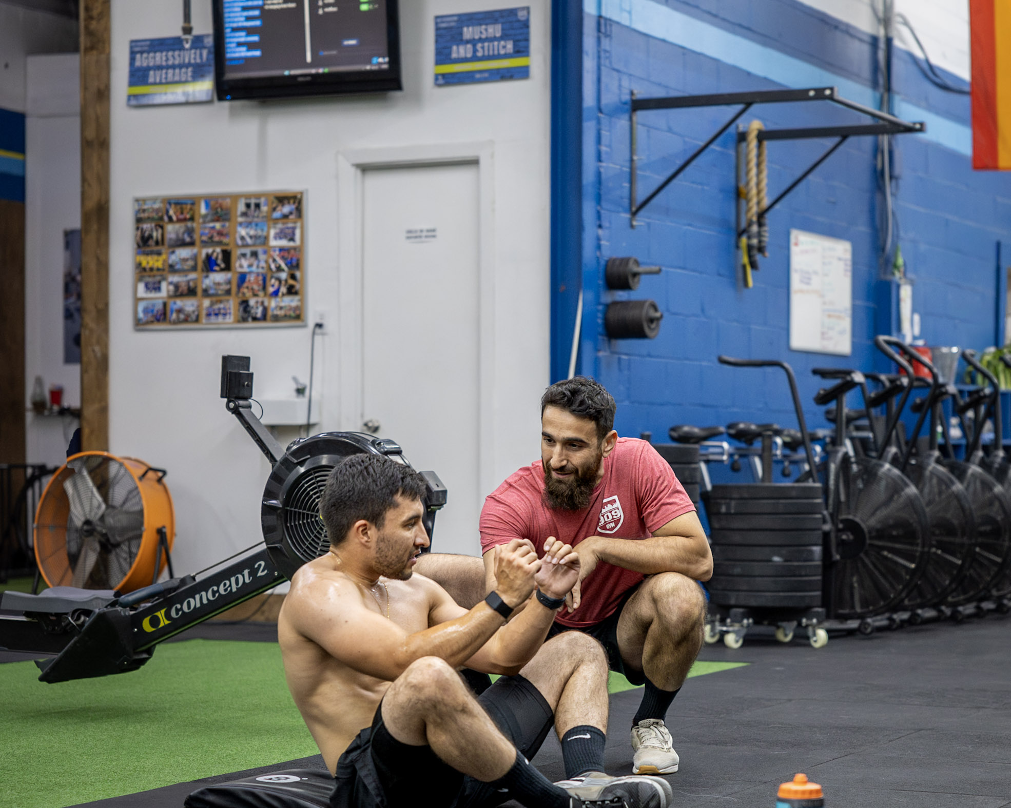 Coach Tameem coaching a 1-on-1 client through deadlift technique